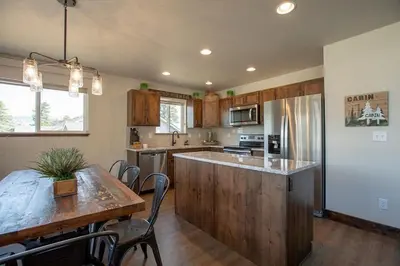 a kitchen with a wooden counter top and a table at The Getaway,Hot Tub, AC, 2miles from RMNP in Estes Park