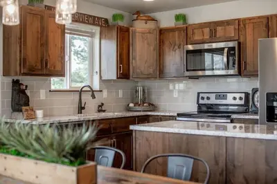 a kitchen with wooden cabinets and a counter top at The Getaway,Hot Tub, AC, 2miles from RMNP in Estes Park