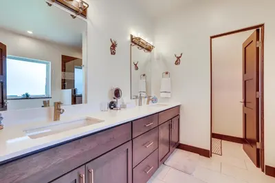 a bathroom with a sink and a large mirror at Hike, Ski, Golf, and Fish Silverthorne Townhome! in Silverthorne