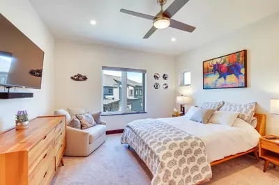 a bedroom with a bed and a ceiling fan at Hike, Ski, Golf, and Fish Silverthorne Townhome! in Silverthorne