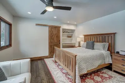 a bedroom with a bed and a ceiling fan at Sunset Cabin - Creekside by Ski Country Resorts in Frisco