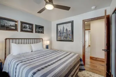 a bedroom with a bed and a ceiling fan at Sunset Cabin - Creekside by Ski Country Resorts in Frisco