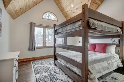 a bedroom with two bunk beds in a house at Sunset Cabin - Creekside by Ski Country Resorts in Frisco