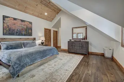 a bedroom with a bed and a dresser at Sunset Cabin - Creekside by Ski Country Resorts in Frisco