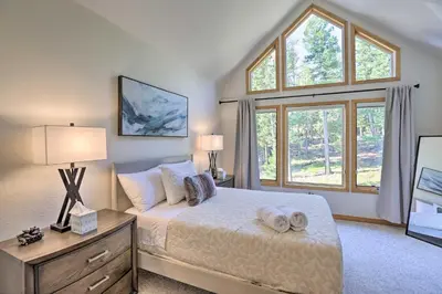 a bedroom with a bed and a large window at Spacious Evergreen Home with Picturesque Views in Evergreen