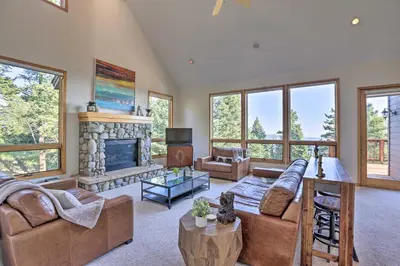 a living room with a couch and a fireplace at Spacious Evergreen Home with Picturesque Views in Evergreen