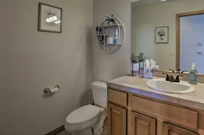 a bathroom with a toilet and a sink at Spacious Evergreen Home with Picturesque Views in Evergreen