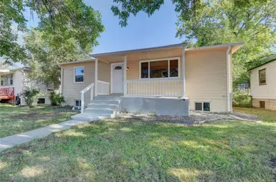 a house with a porch and a yard at 2br 1 bath Upstairs AC WD Barnum West Near Belmar in Denver