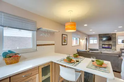 a kitchen and living room with a table and a couch at 9 Mi to Dtwn Quiet South Denver Apartment in Denver
