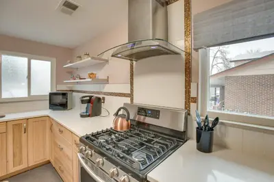 a kitchen with a stove top oven next to a window at 9 Mi to Dtwn Quiet South Denver Apartment in Denver
