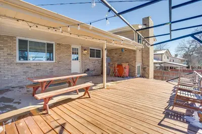 a wooden deck with a picnic bench on a house at 9 Mi to Dtwn Quiet South Denver Apartment in Denver