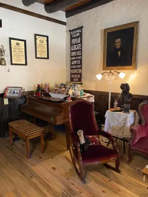 a living room with a piano and a chair at Inn of Glen Haven in Glen Haven