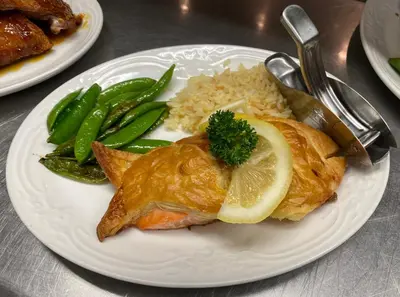 a plate of food with fish and rice and green beans at Inn of Glen Haven in Glen Haven