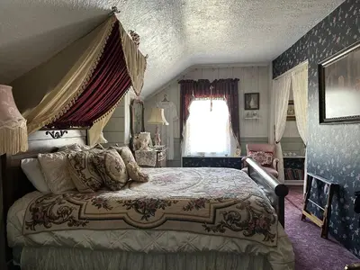 a bedroom with a large bed with a canopy at Inn of Glen Haven in Glen Haven