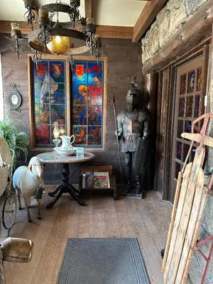 a room with a table and paintings on the wall at Inn of Glen Haven in Glen Haven