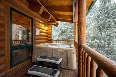 a bathroom in a log cabin with two stools at Iconic Log Cabin Escape - Idaho Springs - Hot Tub in Idaho Springs