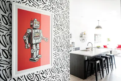 a kitchen with a painting of a robot on the wall at Art-Inspired Loft with Mountain View - Zuni Lofts in Denver
