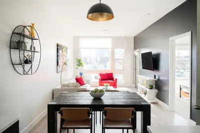 a living room with a table and chairs at Art-Inspired Loft with Mountain View - Zuni Lofts in Denver