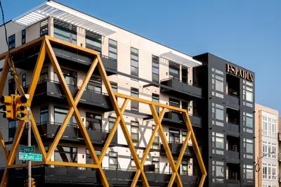 a building with a yellow metal structure in front of it at Gallery Retreat - Skyline Views - Zuni Lofts in Denver