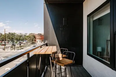 a balcony with a wooden table and two chairs at Contemporary Cool Lifestyle Loft - Zuni Lofts in Denver