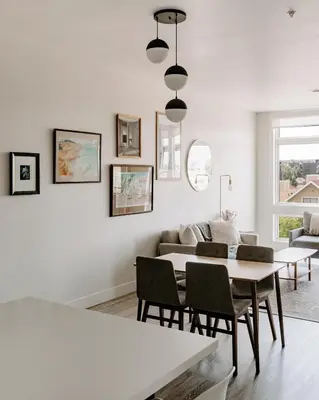 a white living room with a table and chairs at Contemporary Cool Lifestyle Loft - Zuni Lofts in Denver