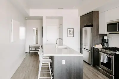 a white kitchen with a sink and a counter at Contemporary Cool Lifestyle Loft - Zuni Lofts in Denver