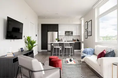 a living room with a couch and a kitchen at A Luxe Point of View - Pet-Friendly - Zuni Lofts in Denver