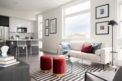 a living room with a couch and a kitchen at A Luxe Point of View - Pet-Friendly - Zuni Lofts in Denver