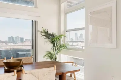 a dining room with a table and a large window at LoHi Clubhouse - Cityscape Panorama - Central LoHi in Denver
