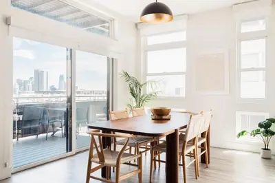 a dining room with a table and chairs and a large window at LoHi Clubhouse - Cityscape Panorama - Central LoHi in Denver