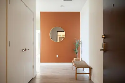 a hallway with a mirror and a table and a chair at LoHi Clubhouse - Cityscape Panorama - Central LoHi in Denver