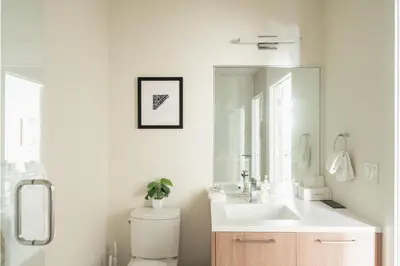 a bathroom with a sink and a toilet and a mirror at Modern Lifestyle - City View - Pet-Friendly - Zuni in Denver