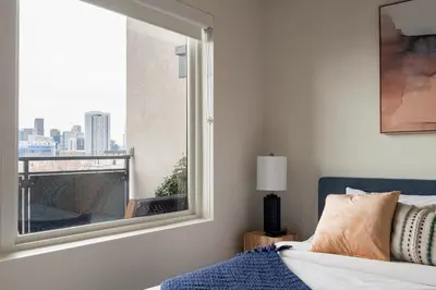 a bedroom with a window with a view of the city at Modern Lifestyle - City View - Pet-Friendly - Zuni in Denver