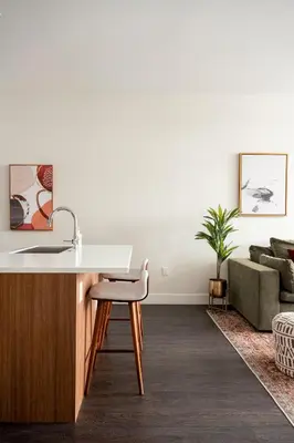 a kitchen with a desk and a chair in a living room at Modern Lifestyle - City View - Pet-Friendly - Zuni in Denver