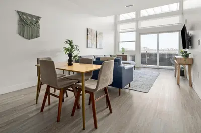 a living room with a table and a couch at On Cloud 9 - Curated Lifestyle Loft - Zuni Lofts in Denver