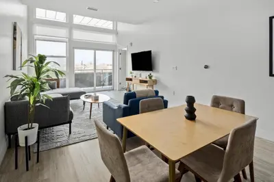 a living room with a table and chairs at On Cloud 9 - Curated Lifestyle Loft - Zuni Lofts in Denver