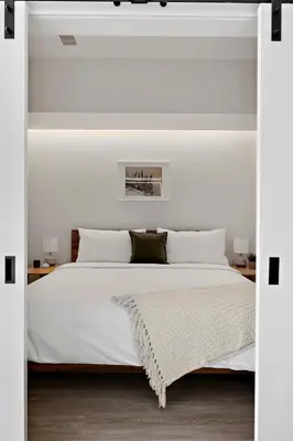 a white bedroom with a large bed with white pillows at Modern Lifestyle Loft with View - Zuni Lofts in Denver