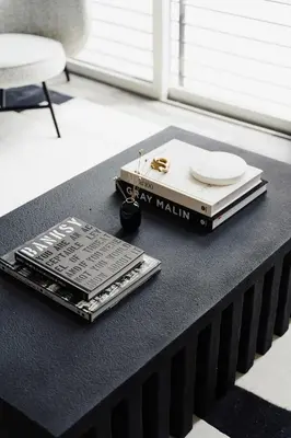 a black table with a book and plates on it at Fifty Shapes of Modern - Skyline Loft - Zuni Lofts in Denver