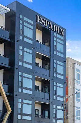 a building with a sign on the side of it at Fifty Shapes of Modern - Skyline Loft - Zuni Lofts in Denver