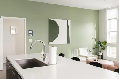 a kitchen with a sink and a living room at Skyline Loft - Sweeping Views - Central LoHi in Denver
