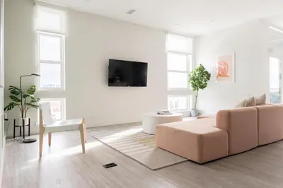 a living room with a couch and a chair at Skyline Loft - Sweeping Views - Central LoHi in Denver