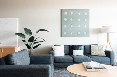 a living room with a blue couch and a table at New Spacious Modern Loft - Center of LoHi in Denver