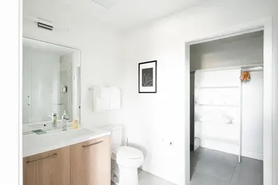 a white bathroom with a toilet and a sink at New Spacious Modern Loft - Center of LoHi in Denver