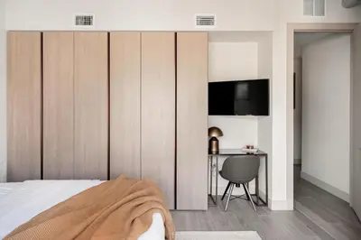 a bedroom with a bed and a desk at Walk to Gameday - Jefferson Park Condo - Tesoro in Denver