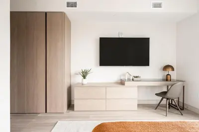 a living room with a desk and a television on a wall at City Views! - Chic Jefferson Park Condo - Tesoro in Denver