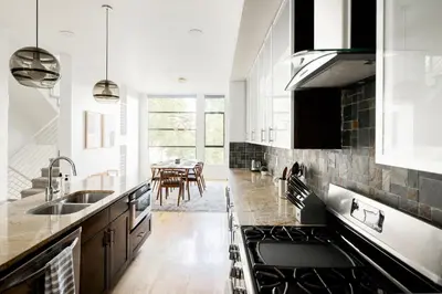 a kitchen with a sink and a dining room at Urban Oasis - Rooftop Delight - Peloton - RiNo in Denver