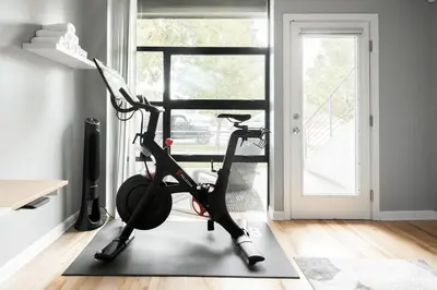 a room with a exercise bike in front of a window at Urban Oasis - Rooftop Delight - Peloton - RiNo in Denver