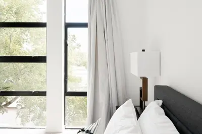 a bedroom with a bed and a large window at Urban Oasis - Rooftop Delight - Peloton - RiNo in Denver