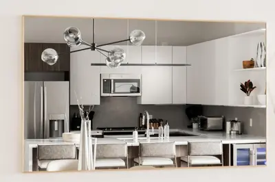 a kitchen with white cabinets and a table with chairs at Gameday Oasis - Private Balcony - Jefferson Park - Tesoro in Denver
