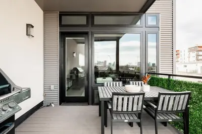 a patio with a table and chairs on a balcony at Gameday Oasis - Private Balcony - Jefferson Park - Tesoro in Denver